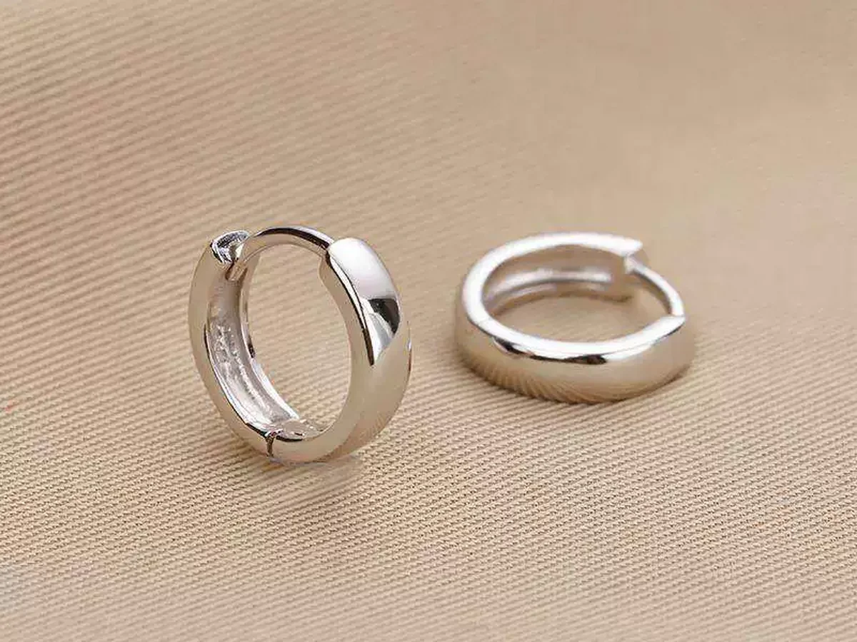 Pair of clean silver earrings before and after cleaning with aluminum foil salt and hot water